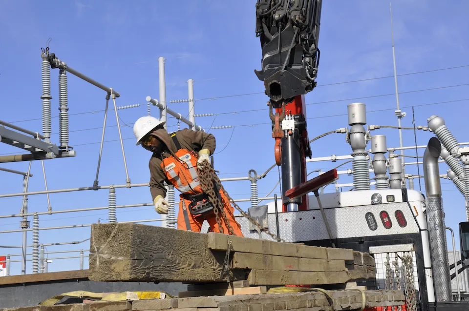 An employee wearing PPE loading a picker truck.